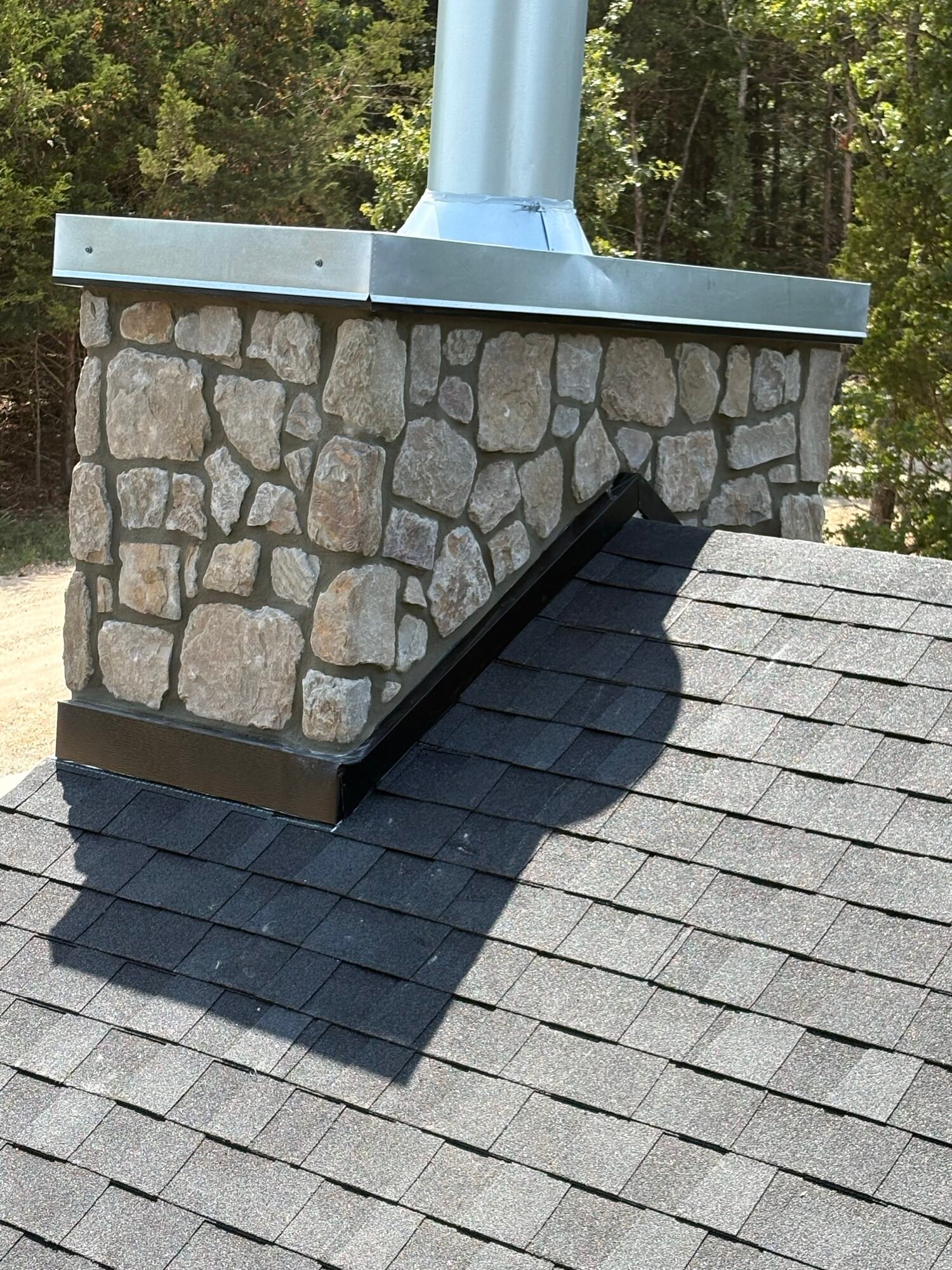 Chimney flashing and shingle roofing detail, alternate angle