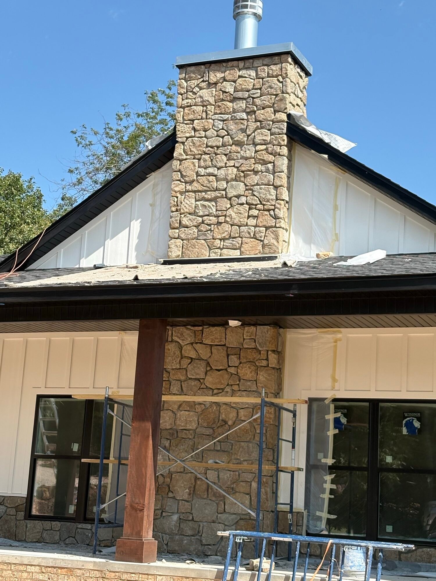 Finished stone chimney on a board-and-batten home
