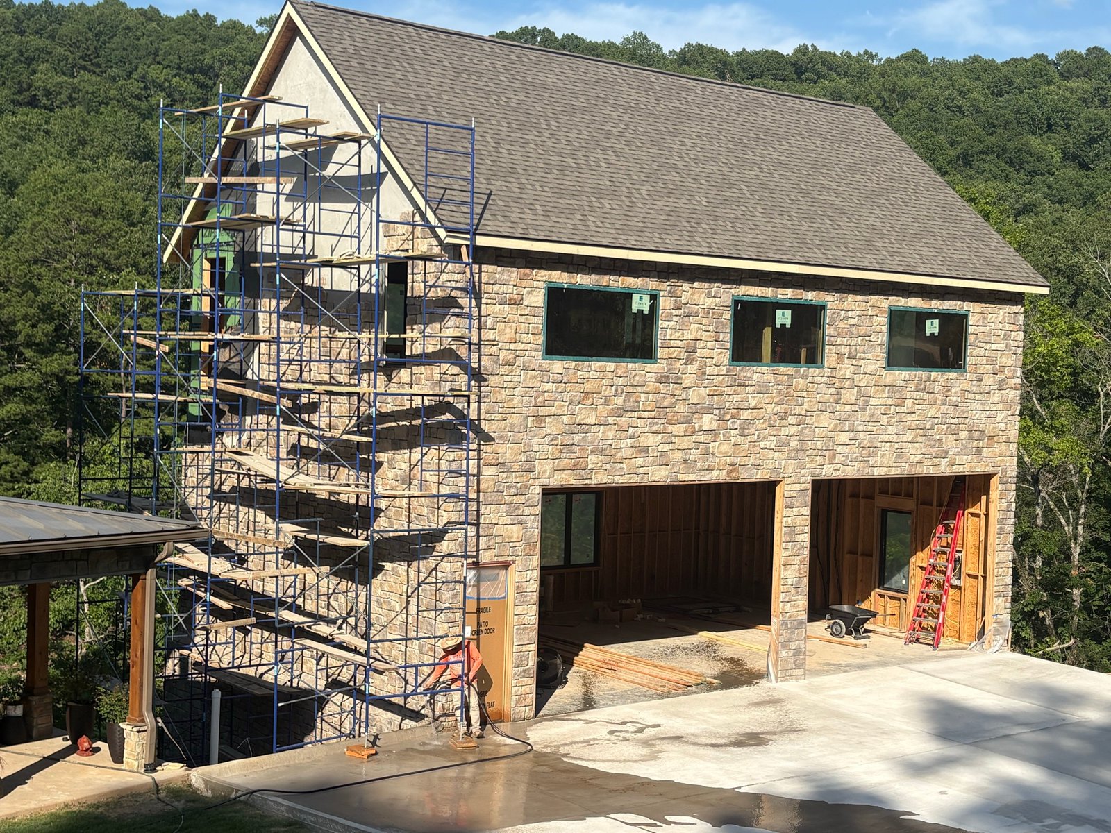 Finished stone exterior being pressure washed