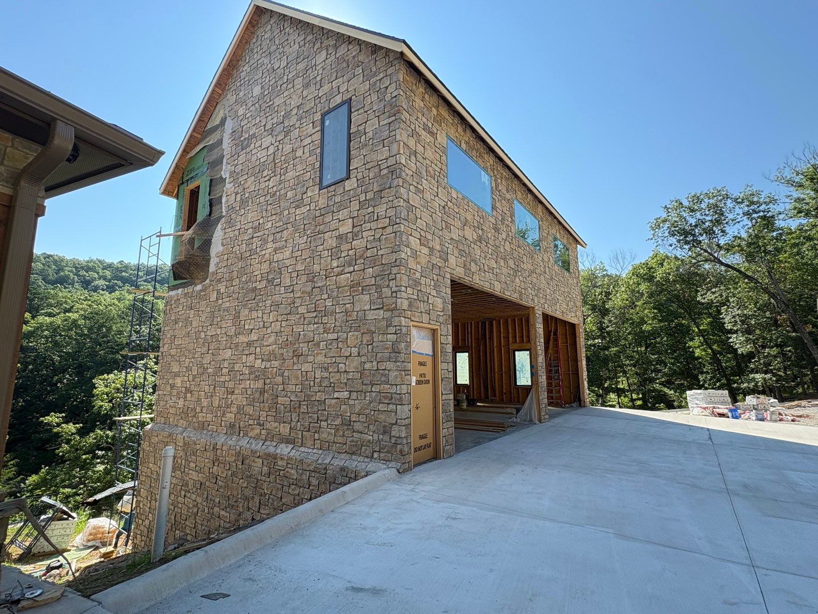 Full-height stone wall on scaffolding
