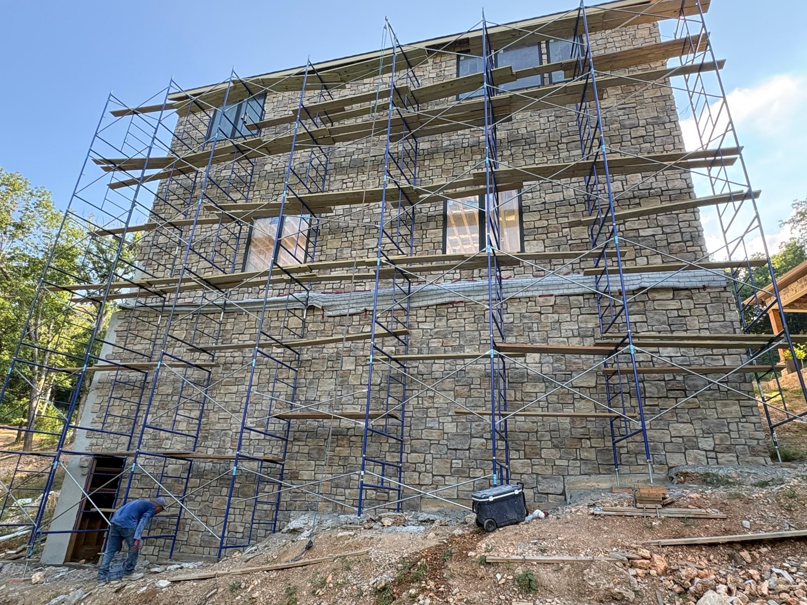 Finished stone masonry exterior on a hillside lot
