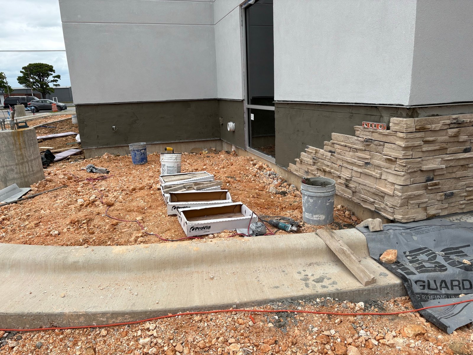 Stucco building corner prepared for stone veneer